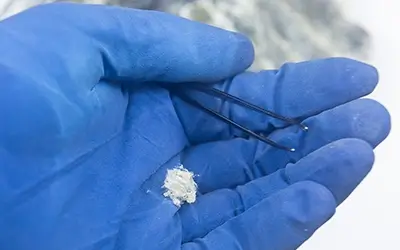 Asbestos inside gloved hand for testing