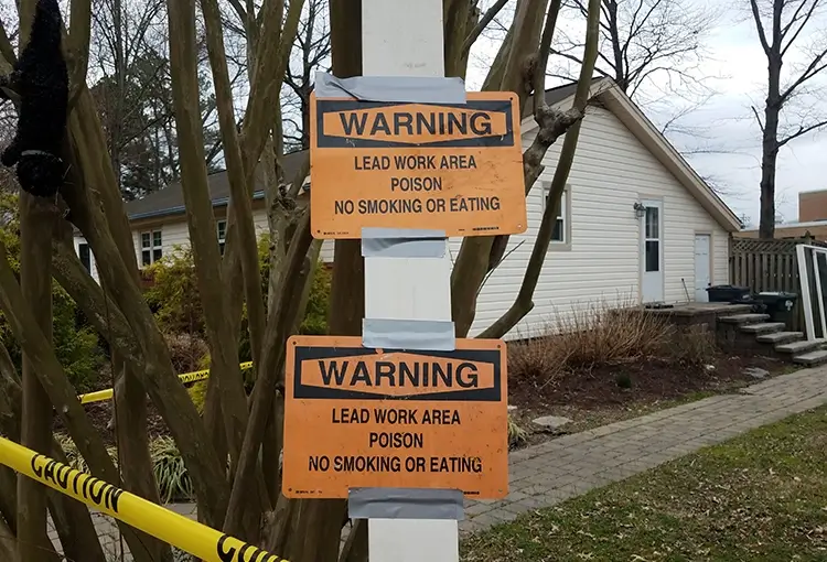 Warning lead work area signs on house renovation site